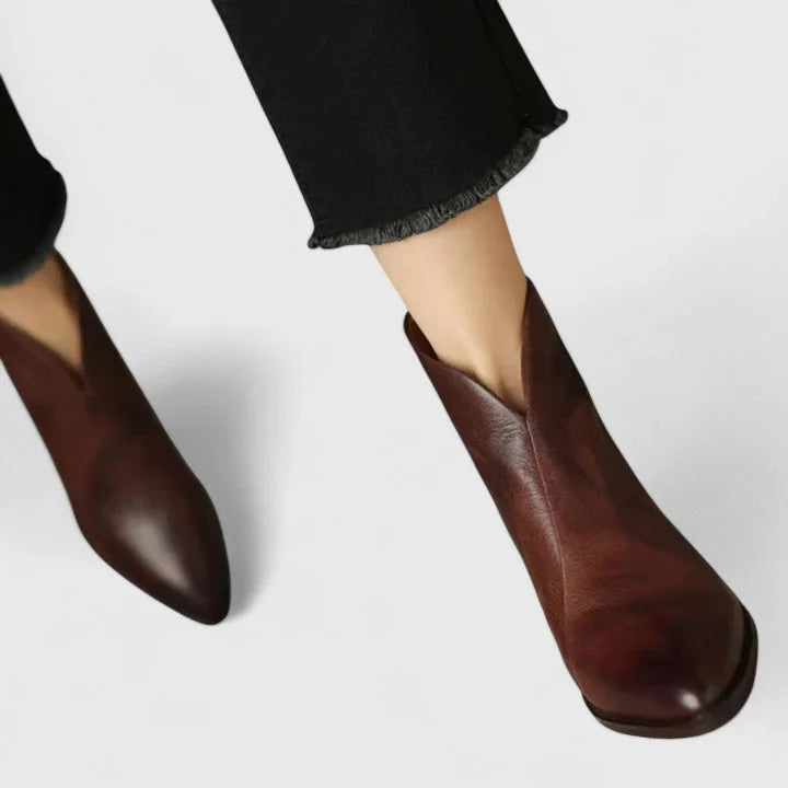 Women's faux leather side zip ankle boots with pointed toe and v-cut shaft