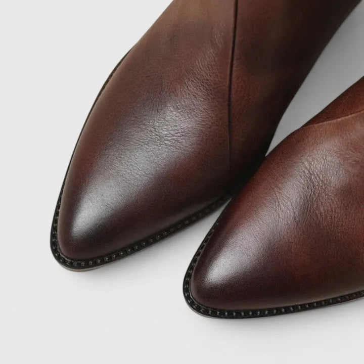 Women's faux leather side zip ankle boots with pointed toe and v-cut shaft