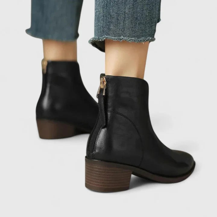 Women's faux leather side zip ankle boots with pointed toe and v-cut shaft