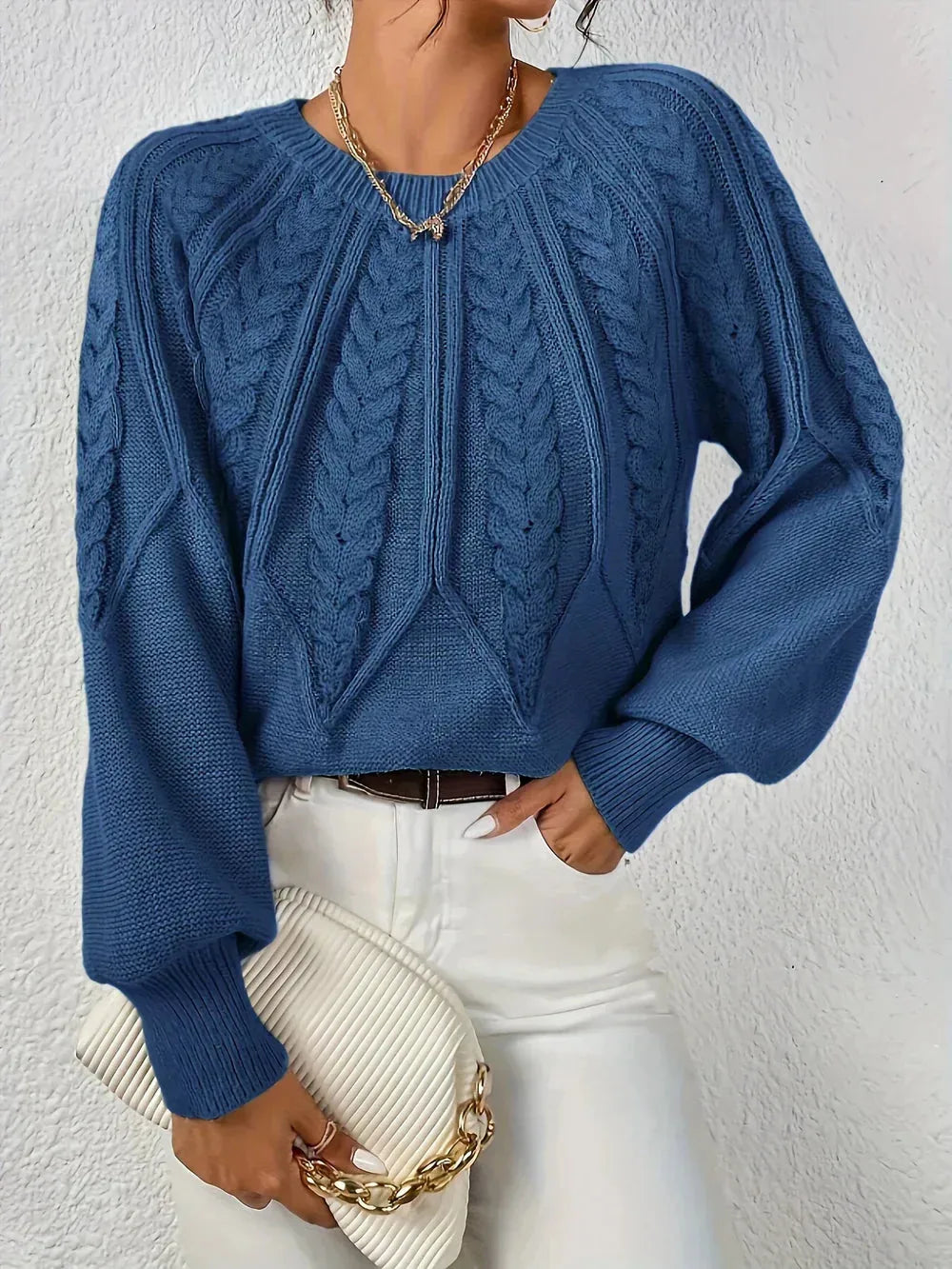 Women's crew neck cable knit sweater with varied pattern