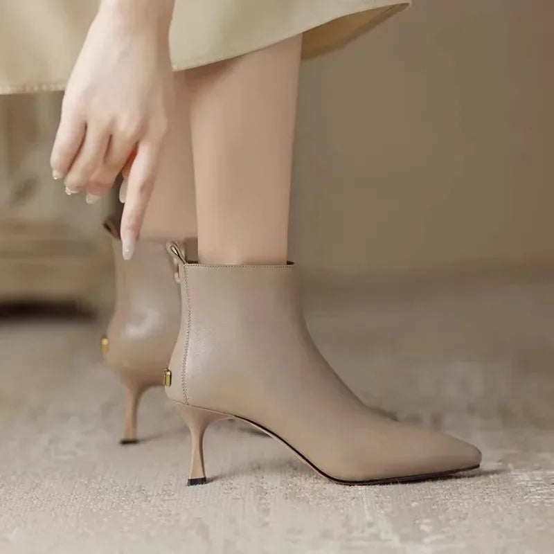 Women's faux leather side zip ankle boots with 'uim' lettering